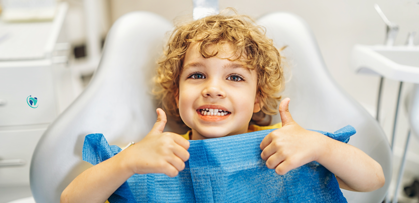 Happy child giving thumbs up at the dentist